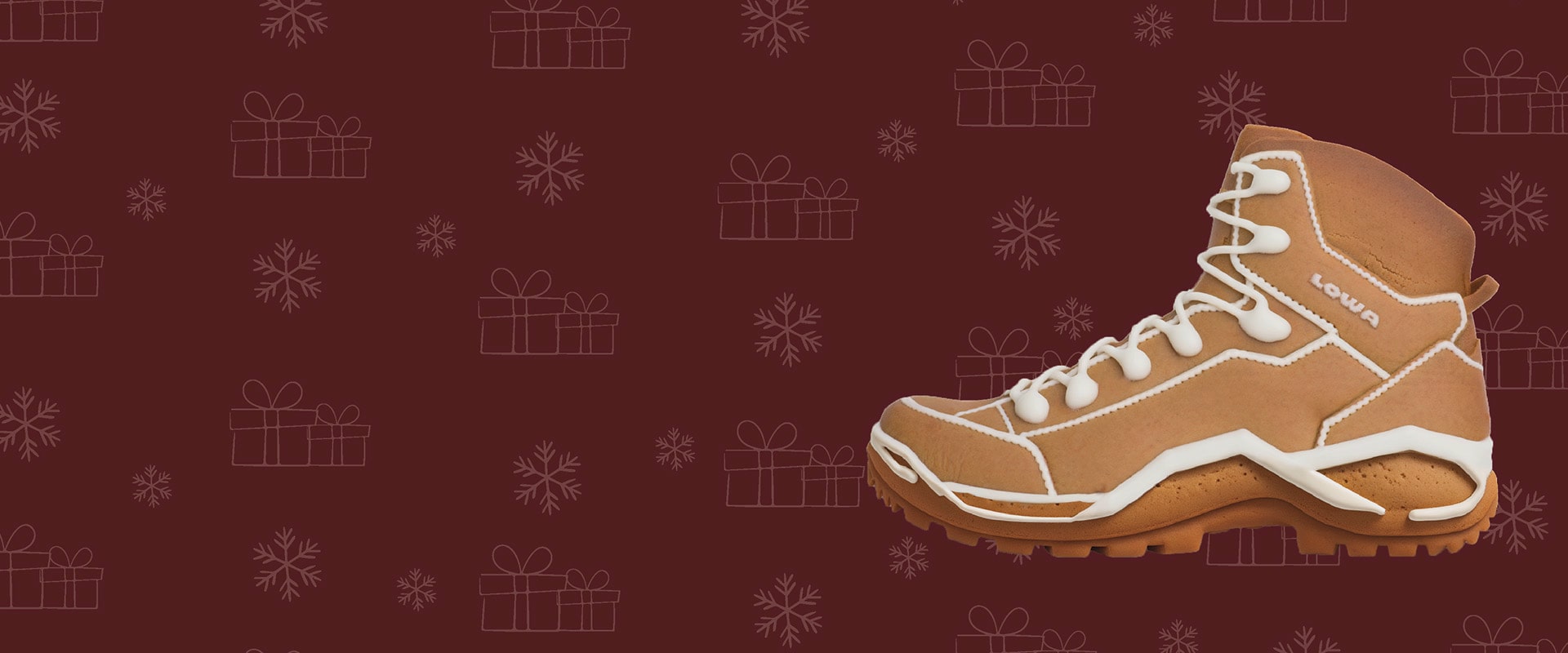 The picture shows a gingerbread shoe from the brand Lowa in front of a dark red background with a snowflake and gift pattern.