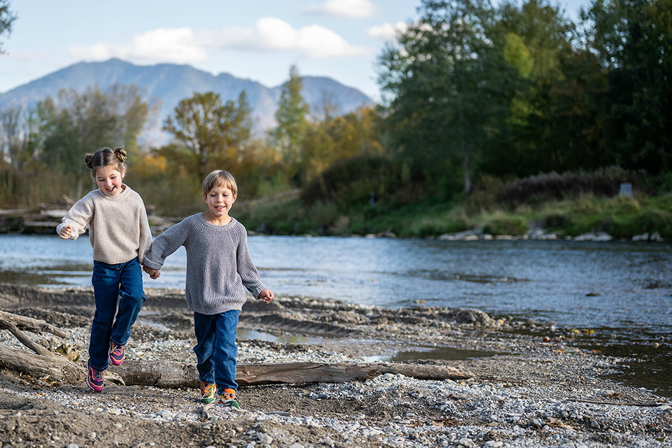 Two children by a river. A cheerful scene close to nature.