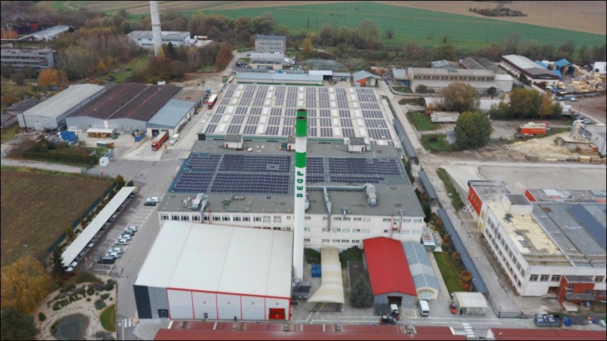 Collection of leather goods: bags, cases and keychains in colourful triangles.